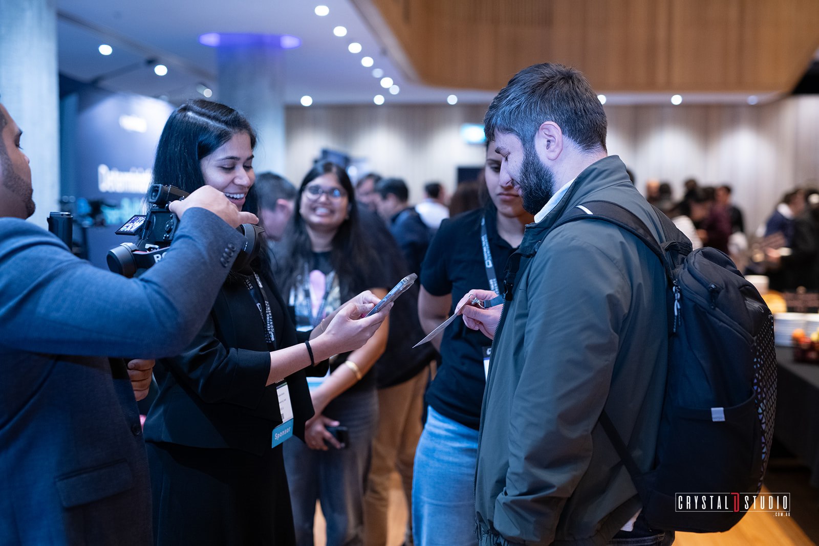Videographer filming a sponsor demoing TeeLead to attendees at Testing Talks Conference Sydney 2026
